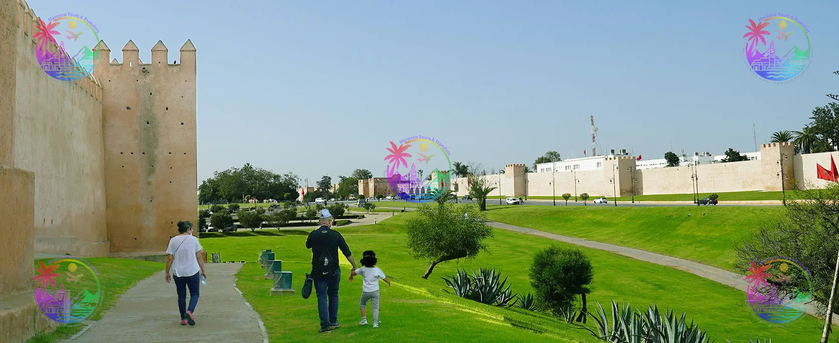 Family walking alongside Rabat’s ancient city walls, part of Morocco Tours & Transfers experiences