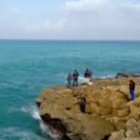 Fishermen on the rocky shore in Oujda, Morocco