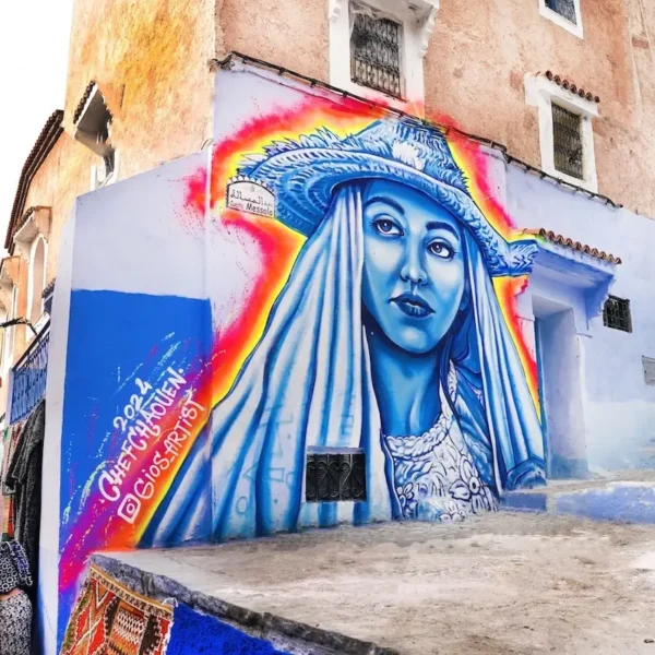 Mural of a local girl painted on a wall in Chefchaouen’s old medina, showcasing the vibrant artistry of the Blue City