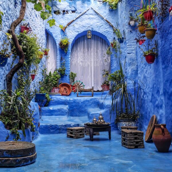 Scenic view of the cities of Tangier and Chefchaouen with traditional Moroccan architecture and blue skies.