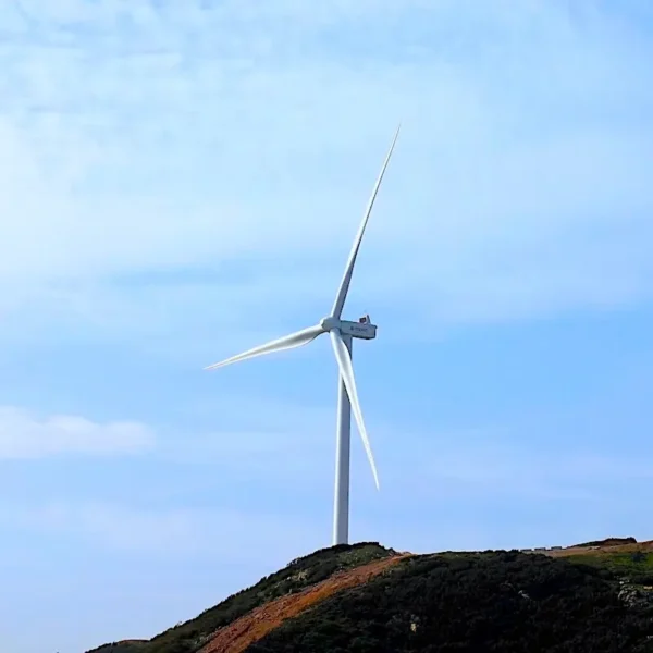 Wind turbine in Oujda region surrounded by scenic landscapes, showcasing Morocco’s renewable energy efforts with Morocco Tours & Transfers