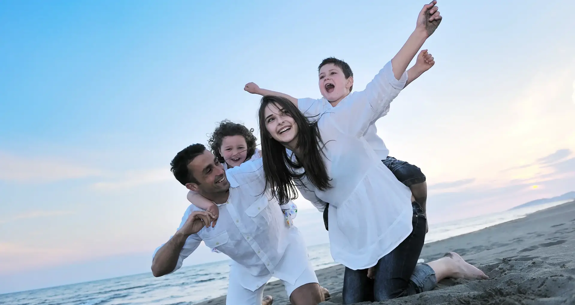 Happy family enjoying a day on the beach in Morocco, part of a customized tour organized by Morocco Tours & Transfers